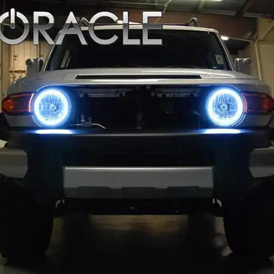 Front view of a Toyota FJ Cruiser with white LED headlight halo rings installed.