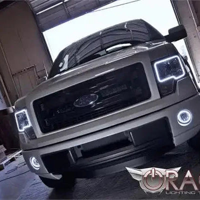 Front view of a Ford F-150 with white LED headlight and fog light halos.